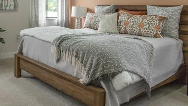 KOO discount code: image shows a beautifully decorated bed with brightly coloured patterns on the bedding