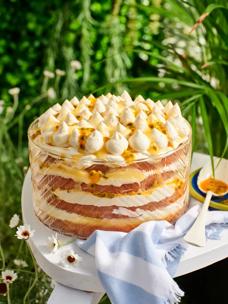 A layered lemon tiramisu cake in a glass dish.