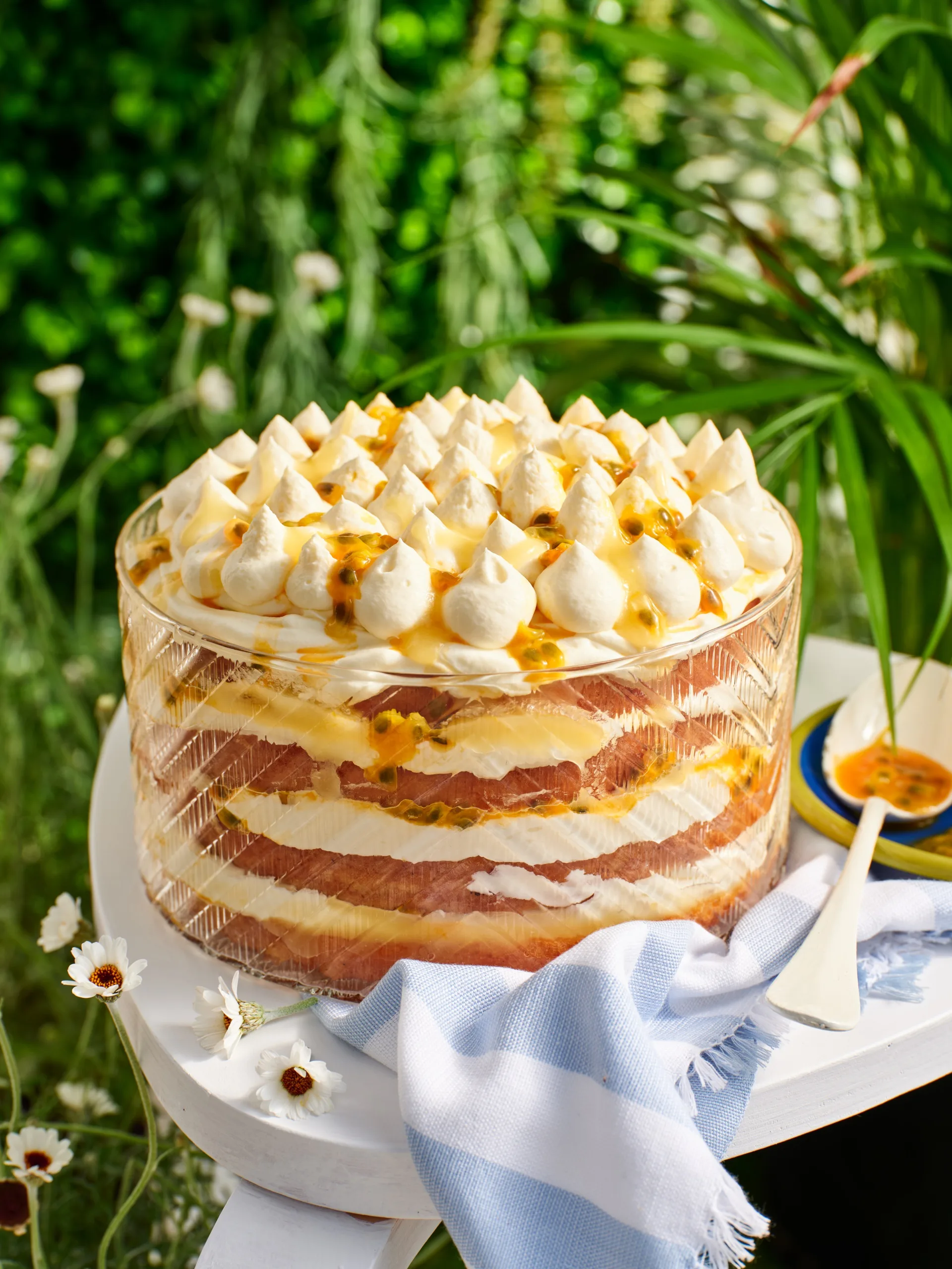 A layered lemon tiramisu cake in a glass dish.
