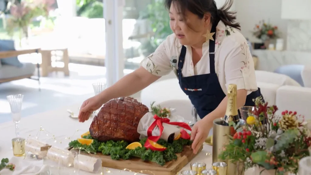 maple glazed ham being put on a table for lunch