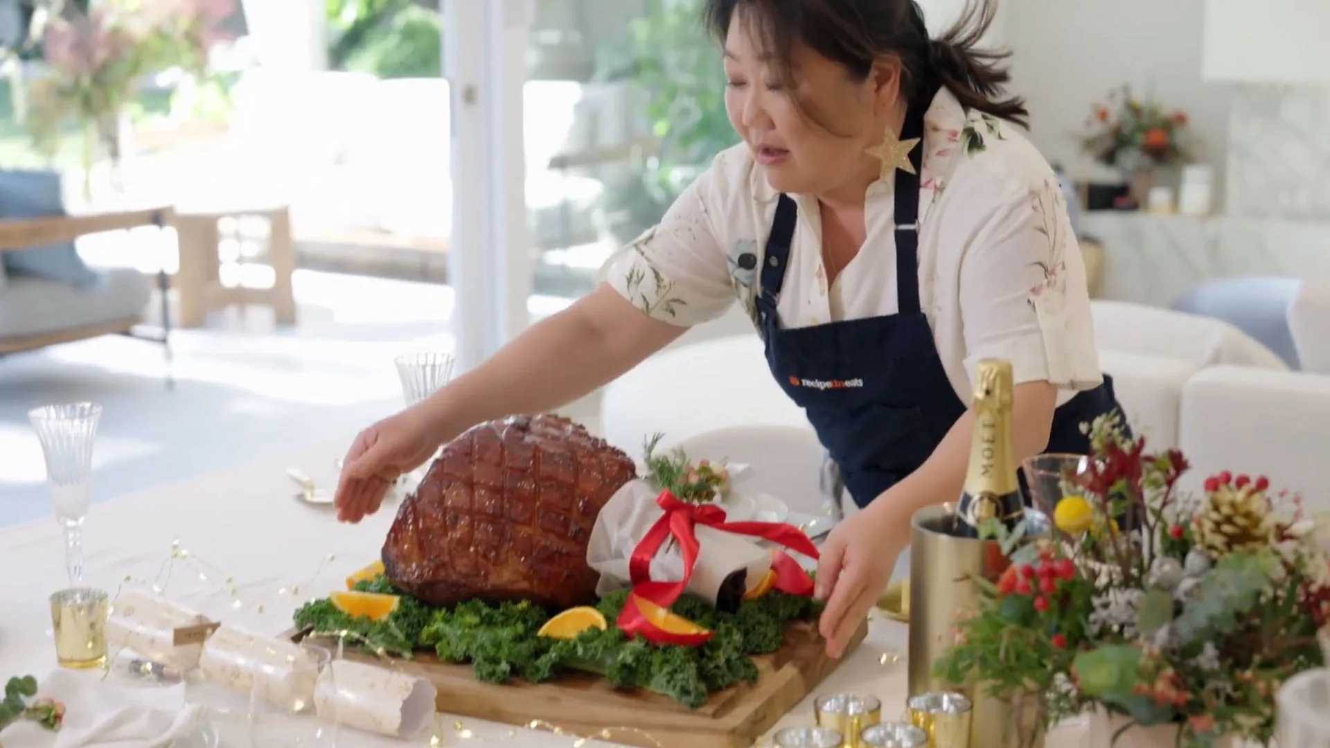maple glazed ham being put on a table for lunch