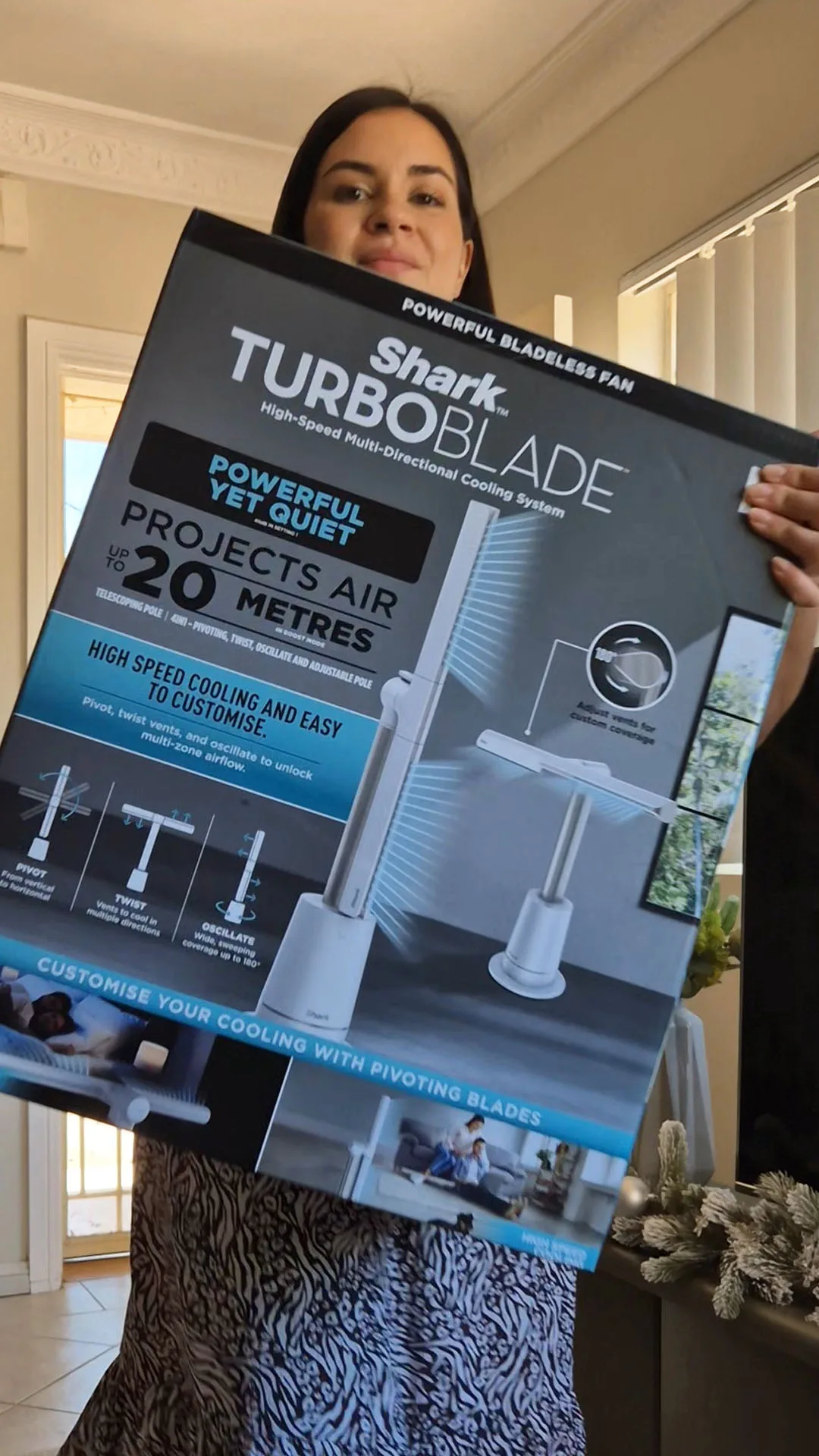 Tahni Mesann holding a Shark TurboBlade fan product box