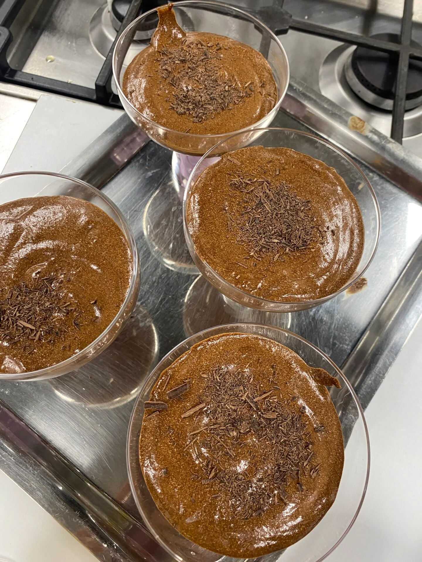 chocolate mousse in cocktail glasses with shaved chocolate on top