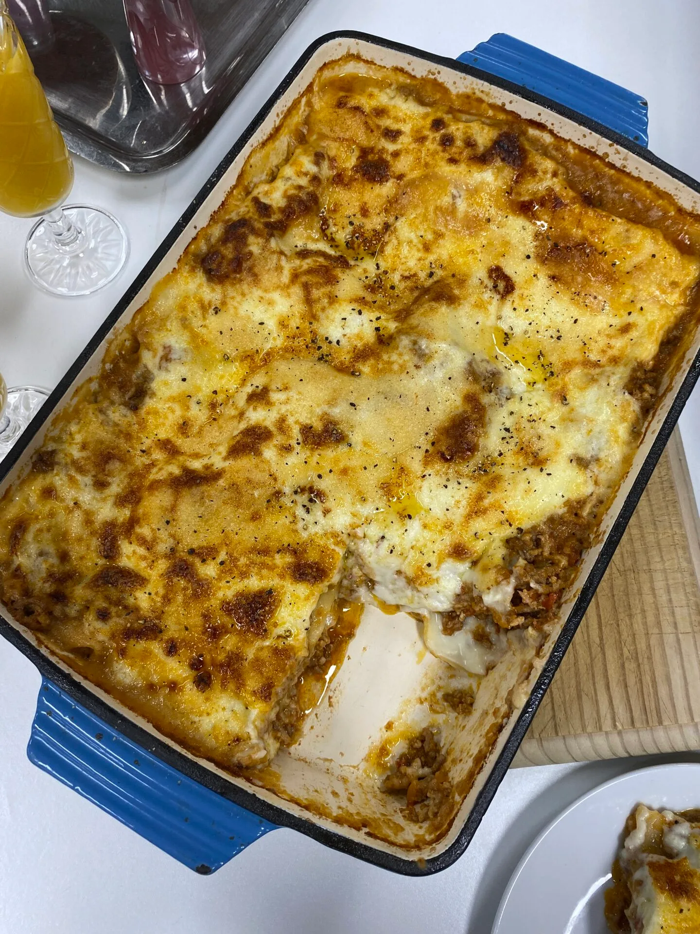 lasagne bolognese in blue cast iron oven dish 
