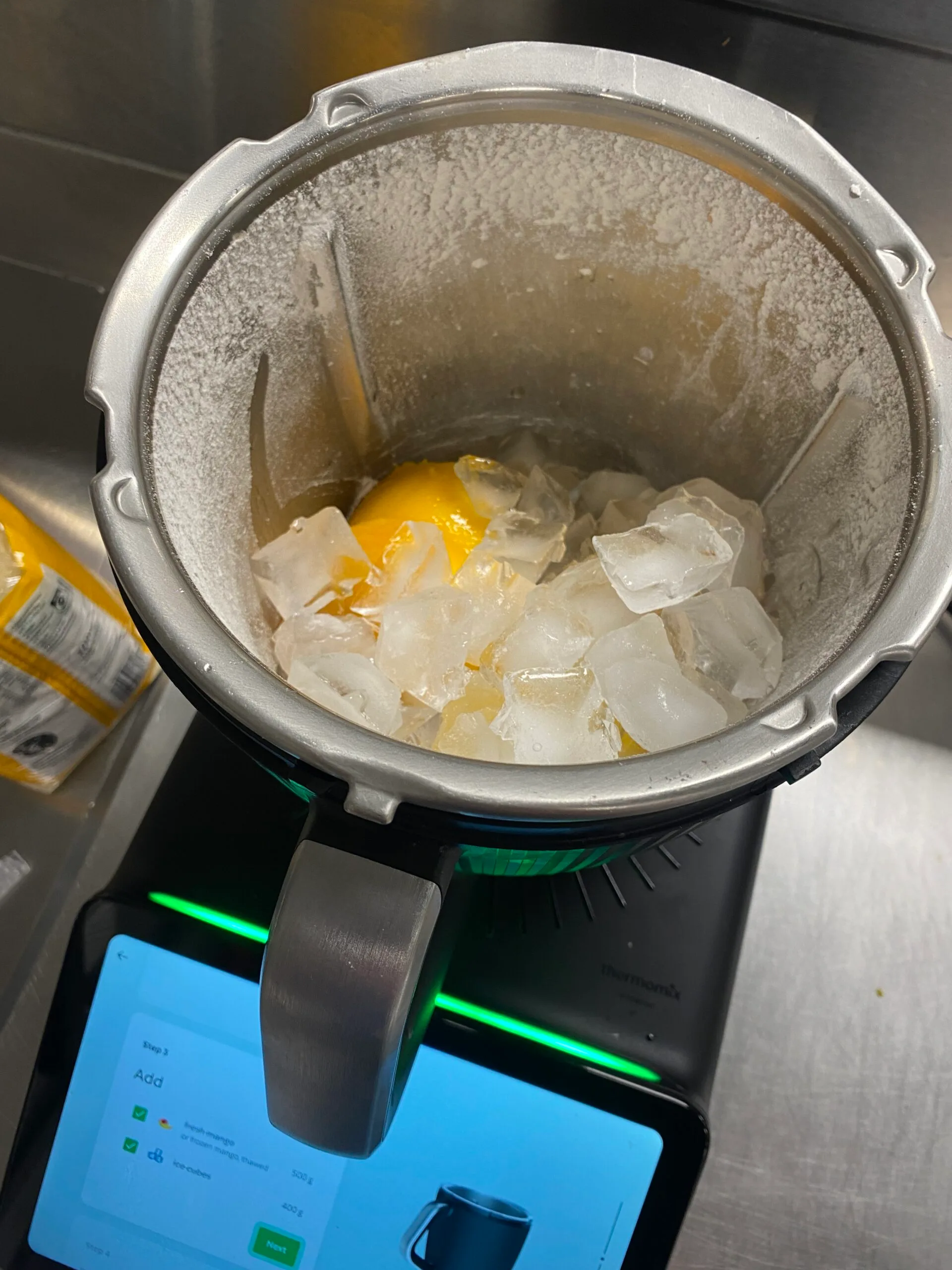 The Thermomix TM7 with mango and ice in it before blitzing for a cocktail.