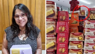 Woman holding panettone box, right stacks of panettone in a Sydney deli
