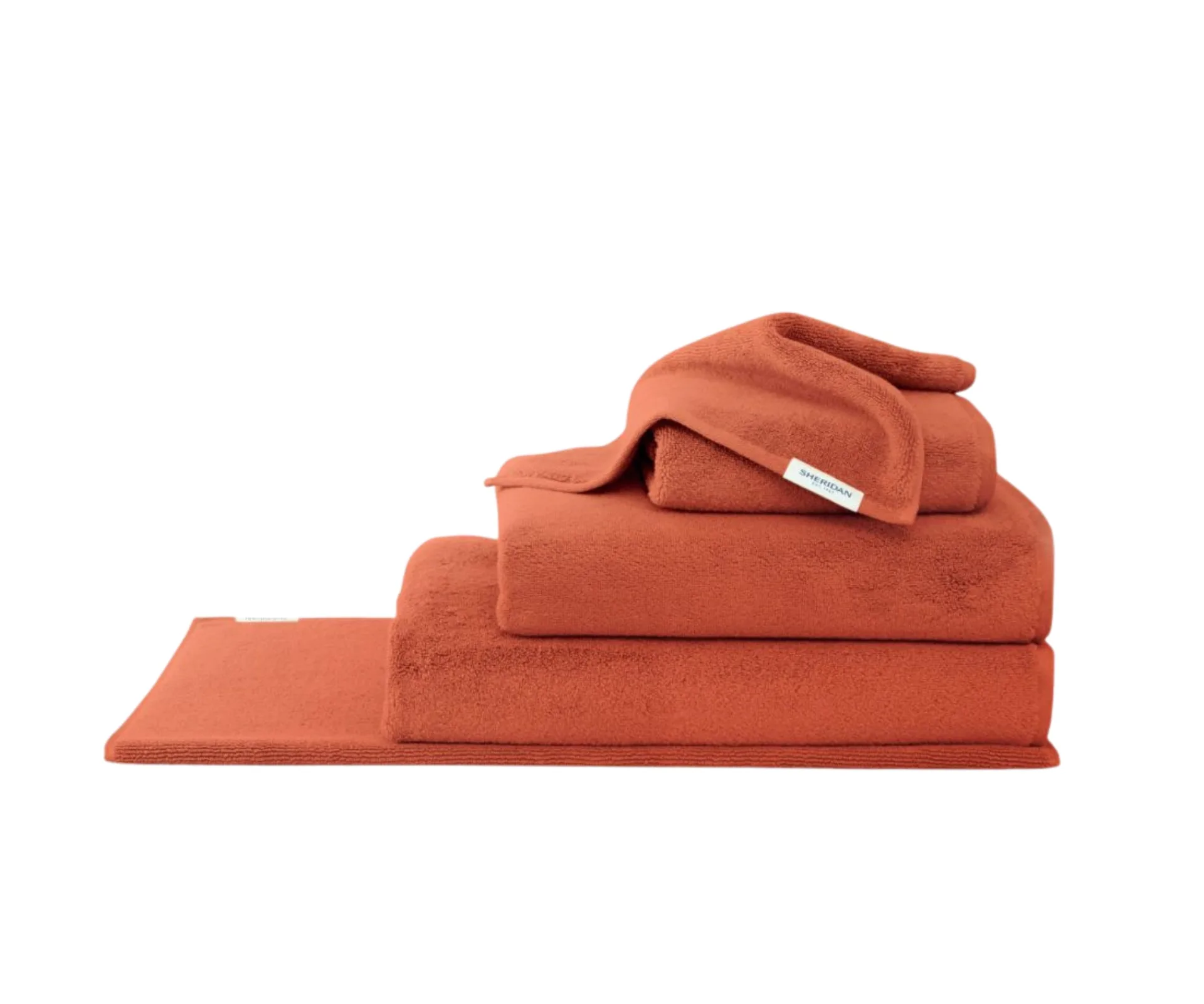 burnt orange towel set layered in pile from sheridan
