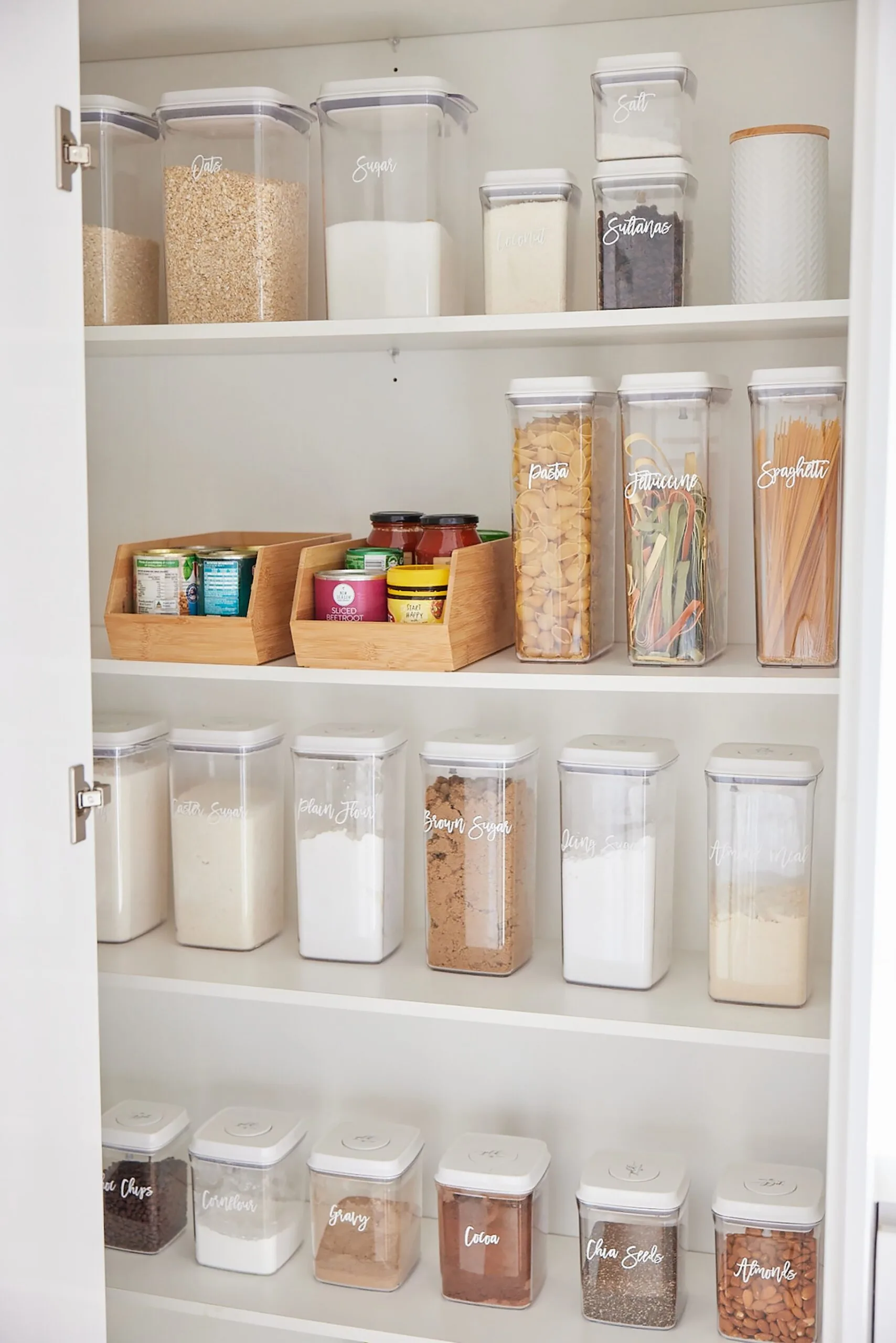 Organised pantry with staples in clearly marked containers.