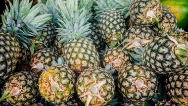 australian pineapple oversupply with pineapples piled up at supermarket