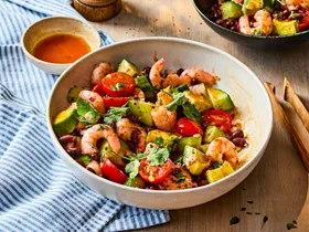 prawn and black bean salad in bowl with pepper shaker behind it