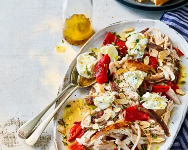 chicken capsicum salad with anchovies and bread in long oval bowl