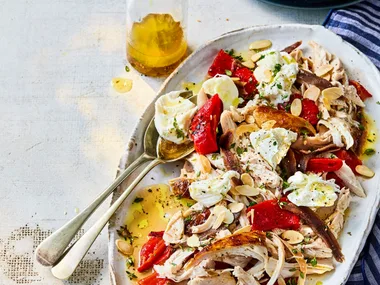 chicken capsicum salad with anchovies and bread in long oval bowl
