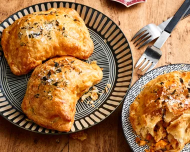 chicken and vegetable pasties with nigella seeds on top on round plates
