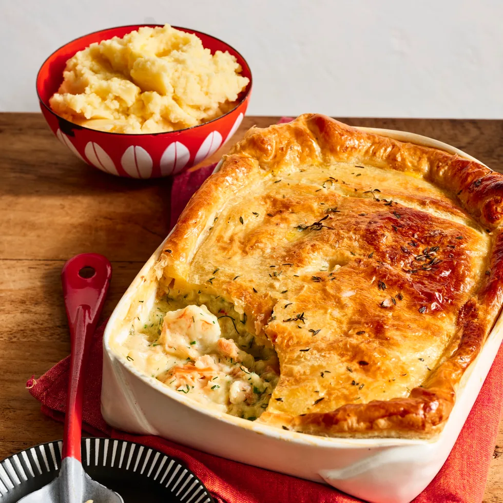 colins fish pie in rounded rectangular dish with one spoon taken out