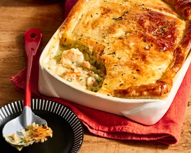 colins fish pie in rounded rectangular dish with one spoon taken out