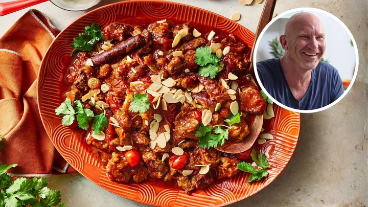 Lamb tagine recipe served on a bright orange plate. Chef Matt Moran's headshot is inset.