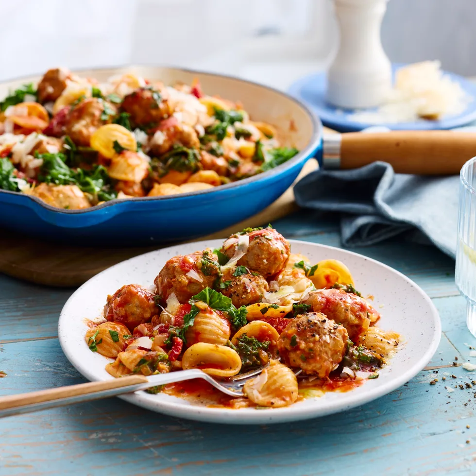 creamy sausage pasta with orecchiette pasta with fork coming out of bowl