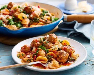 creamy sausage pasta with orecchiette pasta with fork coming out of bowl