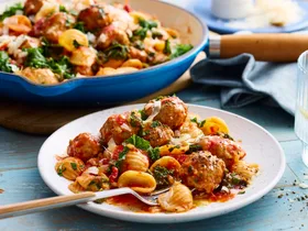 creamy sausage pasta with orecchiette pasta with fork coming out of bowl