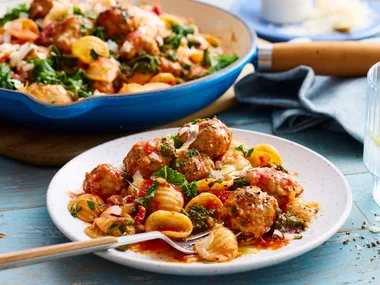 creamy sausage pasta with orecchiette pasta with fork coming out of bowl