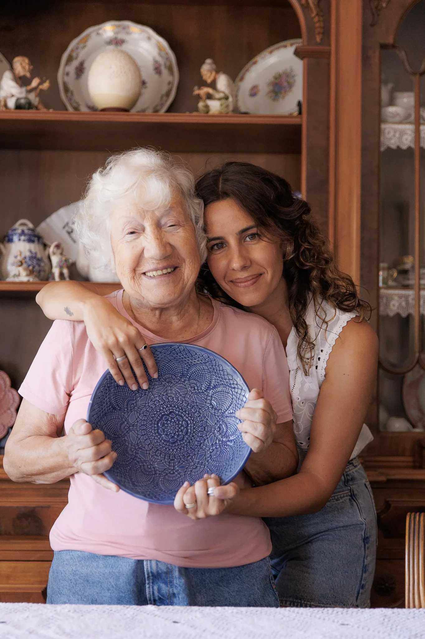 Ceramacist Ana Araujo with her grandmother holding one of her ceramic pieces 