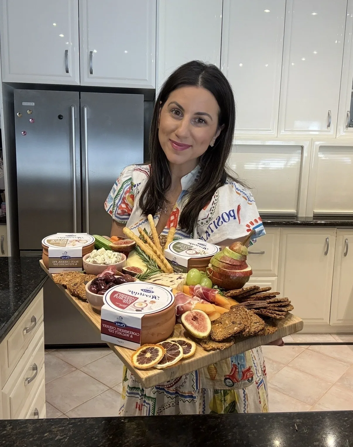Emily Christos, home cook, holding a cheese platter 