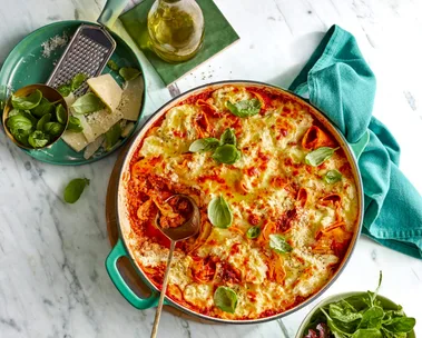 frying pan lasagne with basil sprinkled on top and mixed leaf salad on the side