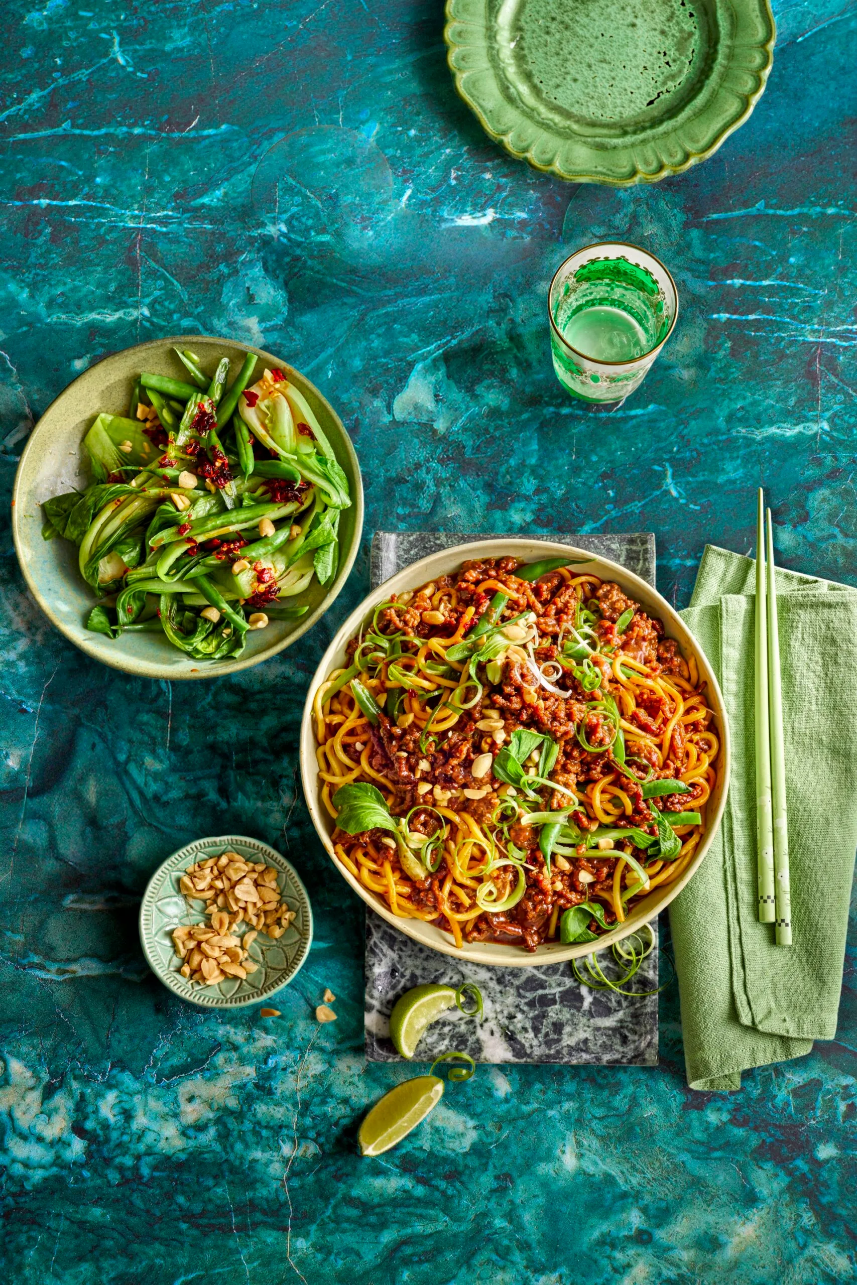 sticky mince beef noodles with asian herbs on top and mixed salad to the side