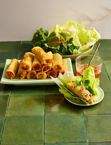 clarissa feildels vietnamese spring rolls stacked on rectangular plate with lettuce cup on the side