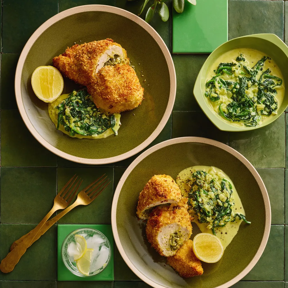 colin fassnidges homemade chicken kiev with kievs cut in cross section, herby salad and lemon wedge