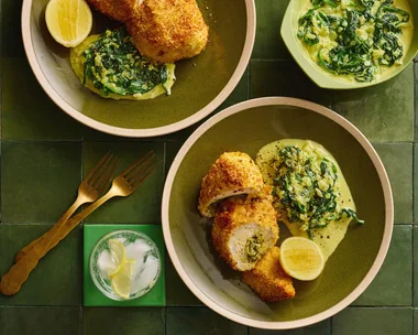 colin fassnidges homemade chicken kiev with kievs cut in cross section, herby salad and lemon wedge