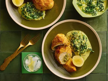 colin fassnidges homemade chicken kiev with kievs cut in cross section, herby salad and lemon wedge