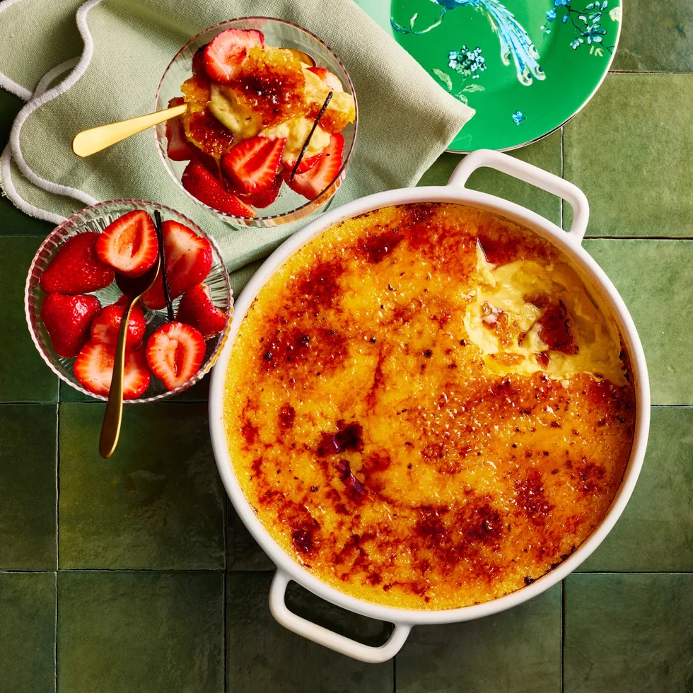creme brulee in large pot for sharing with strawberries on the side