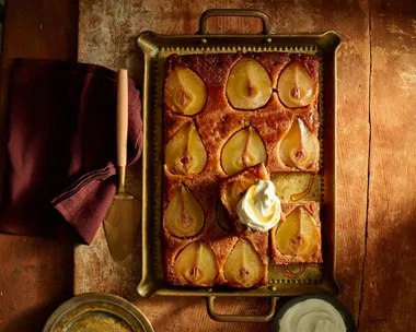 pear upside down cake with slices of pear in top of cake in metal rectangular tray