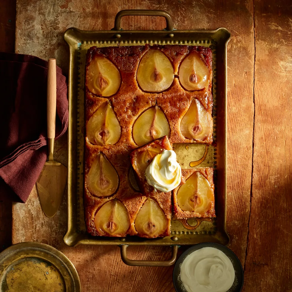 pear upside down cake with slices of pear in top of cake in metal rectangular tray