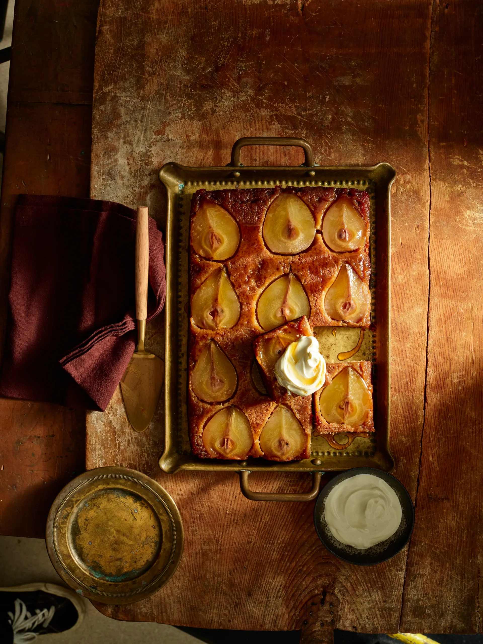 pear upside down cake with slices of pear in top of cake in metal rectangular tray