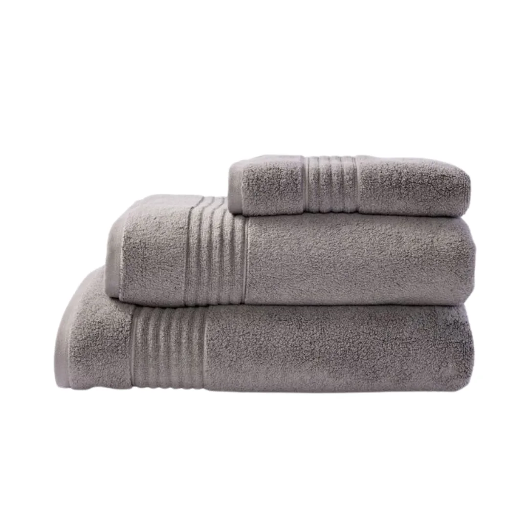 A set of three grey towels: one small hand towel, one bath towel, and one large bath sheet, folded neatly and stacked