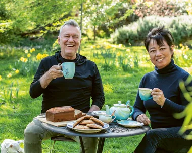 Jimmy Barnes and Jane Barnes drinking tea togerther outdoors at their home