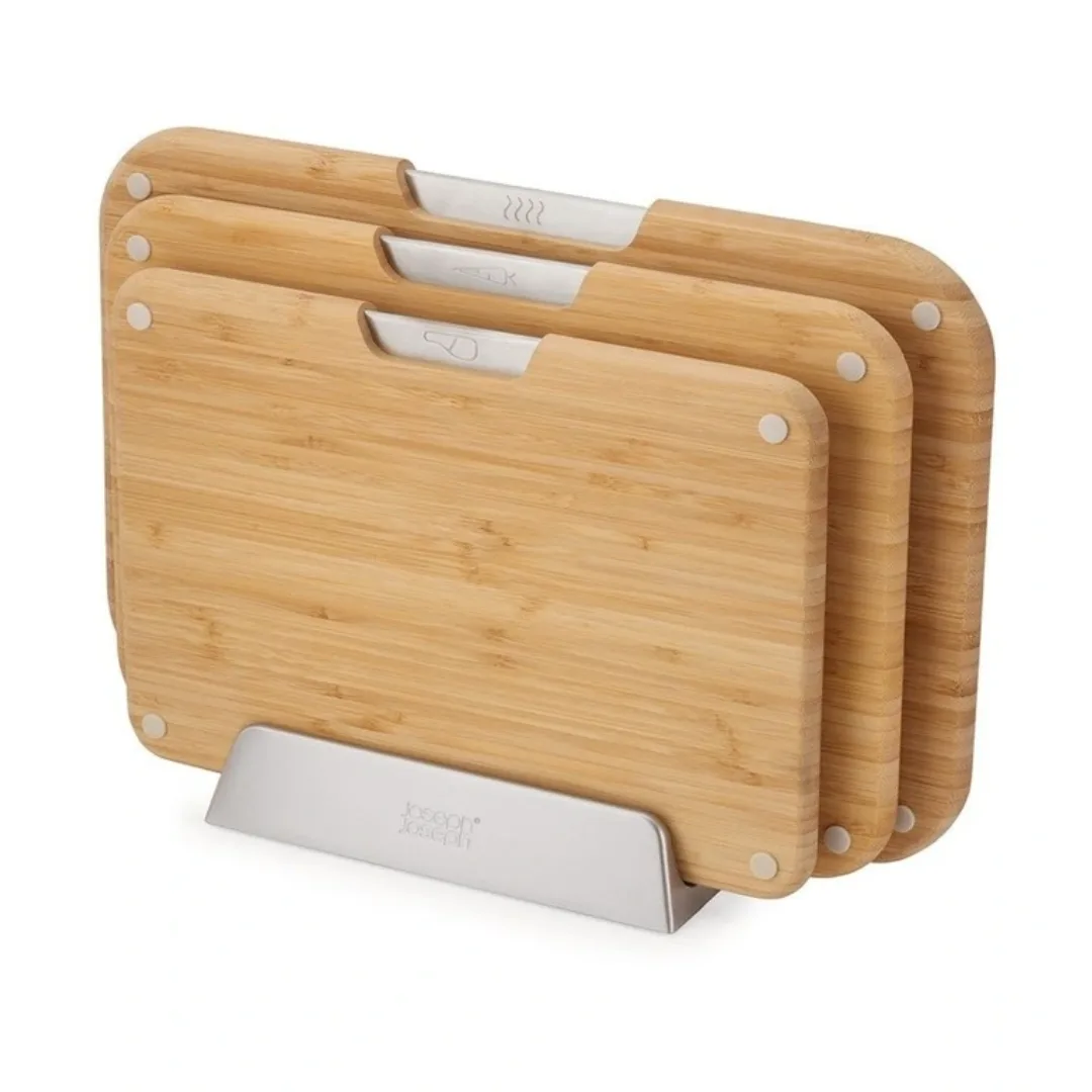 A set of three wooden nested chopping boards with silver detailing and the Joseph Joseph logo on the base