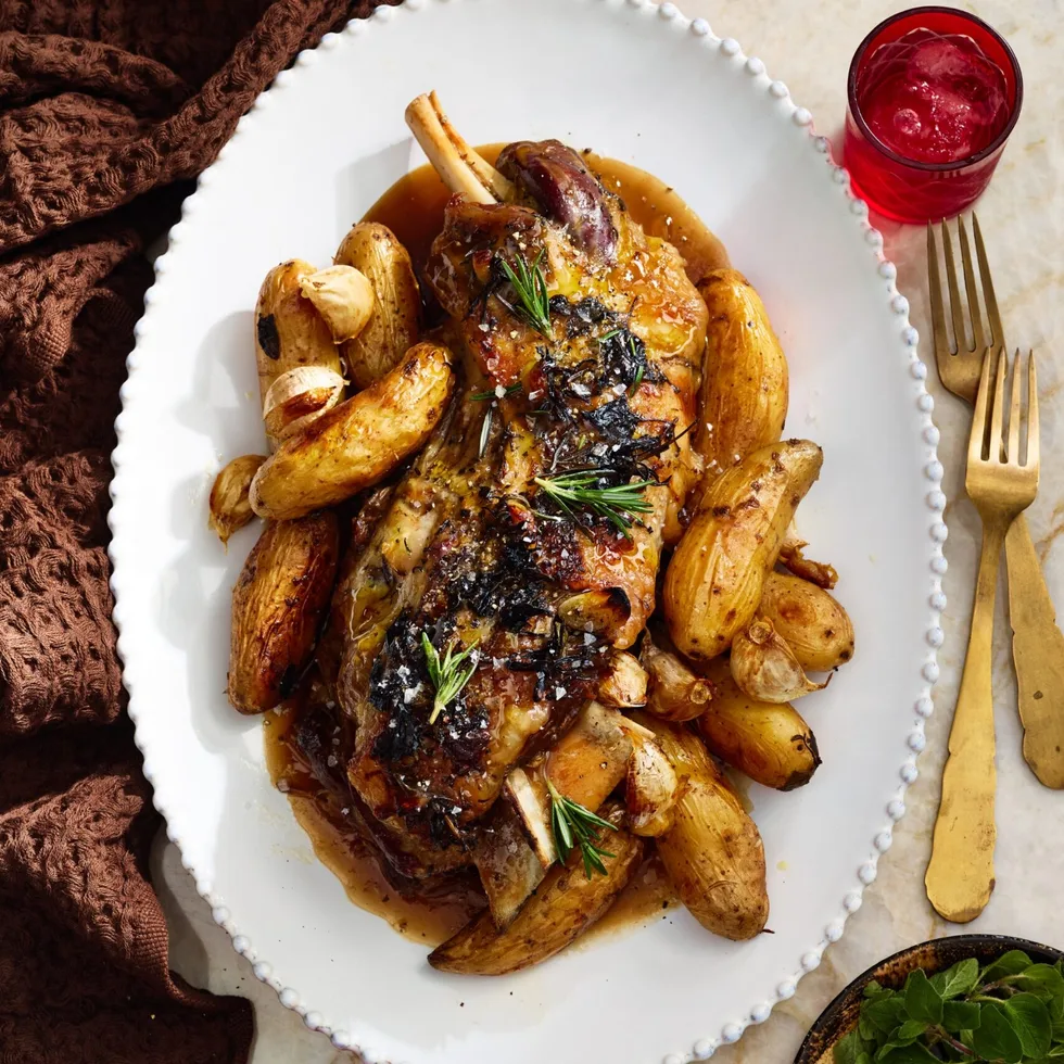 roast lamb with kipfler potatoes on oval plate