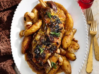 roast lamb with kipfler potatoes on oval plate