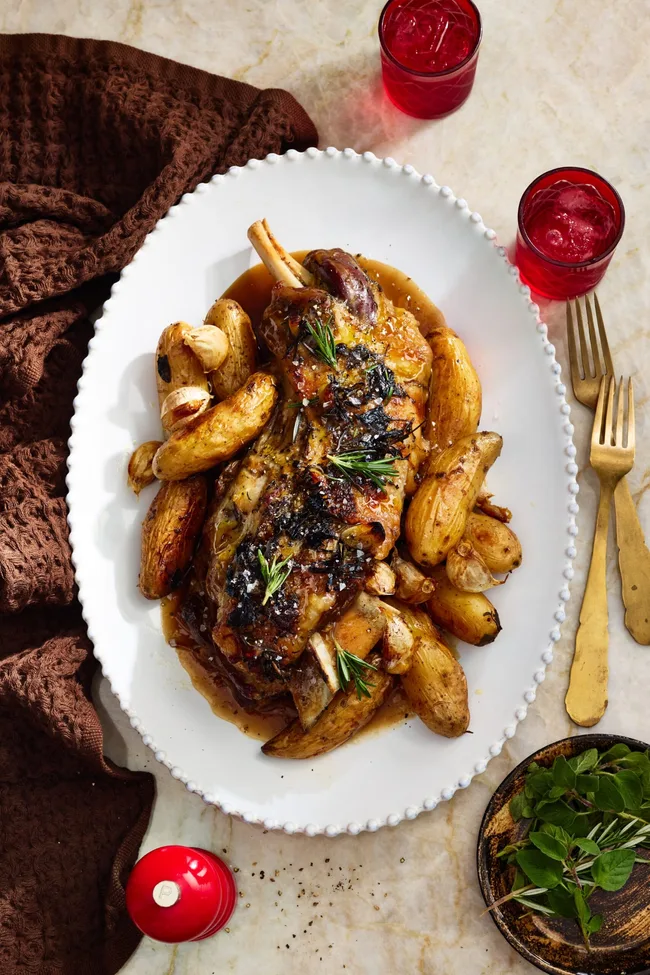 roast lamb with kipfler potatoes on oval plate