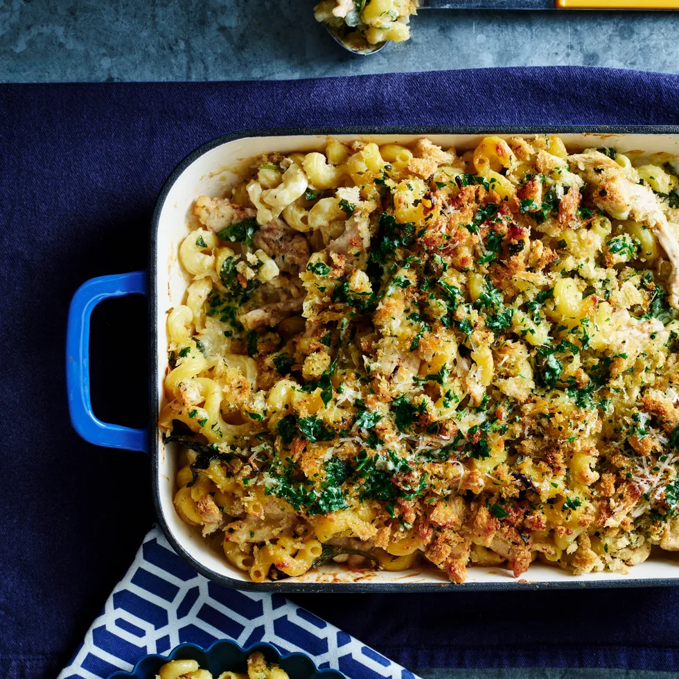 chicken kiev pasta bake in tray with dark blue background