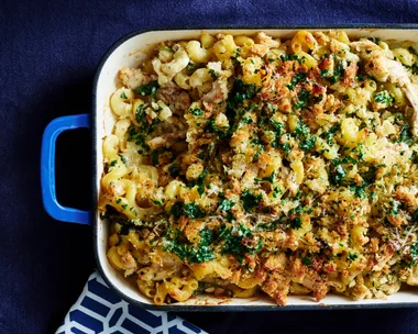 chicken kiev pasta bake in tray with dark blue background