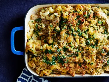 chicken kiev pasta bake in tray with dark blue background