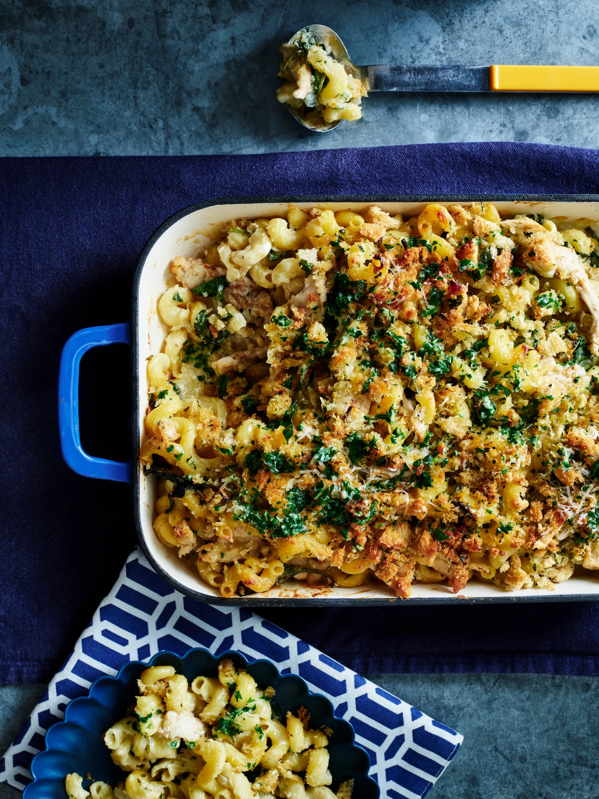 chicken kiev pasta bake in tray with dark blue background