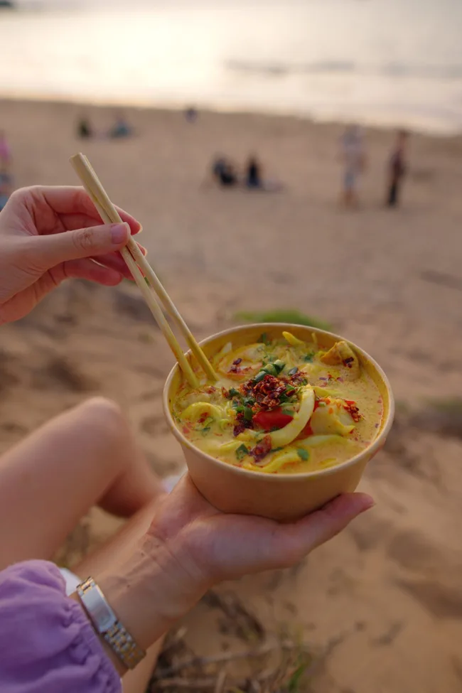 mindil makrets on mindil beach darwin with close up of laksa in takeaway bowl