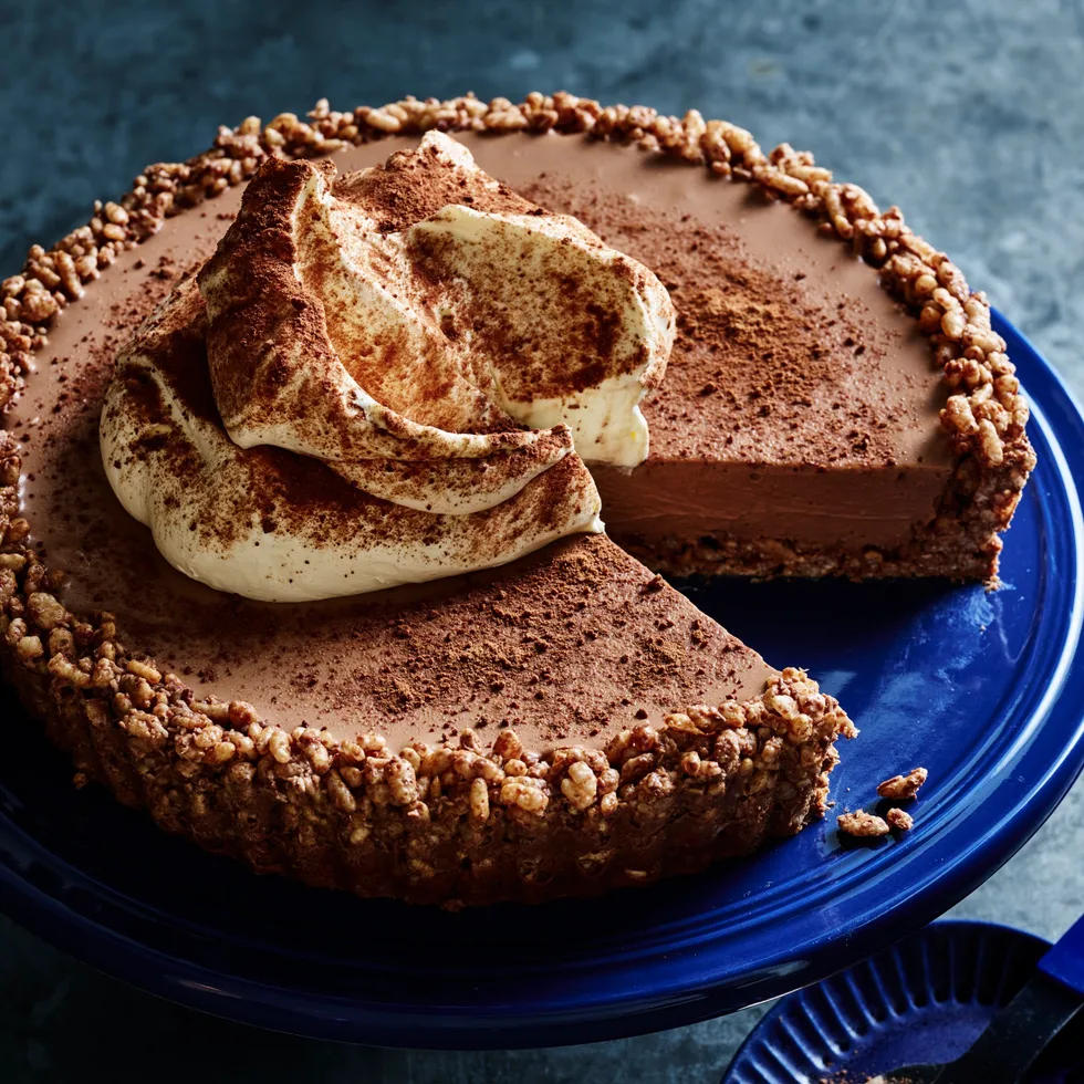 milo cheesecake with extra milo on top and chocolate crackle base