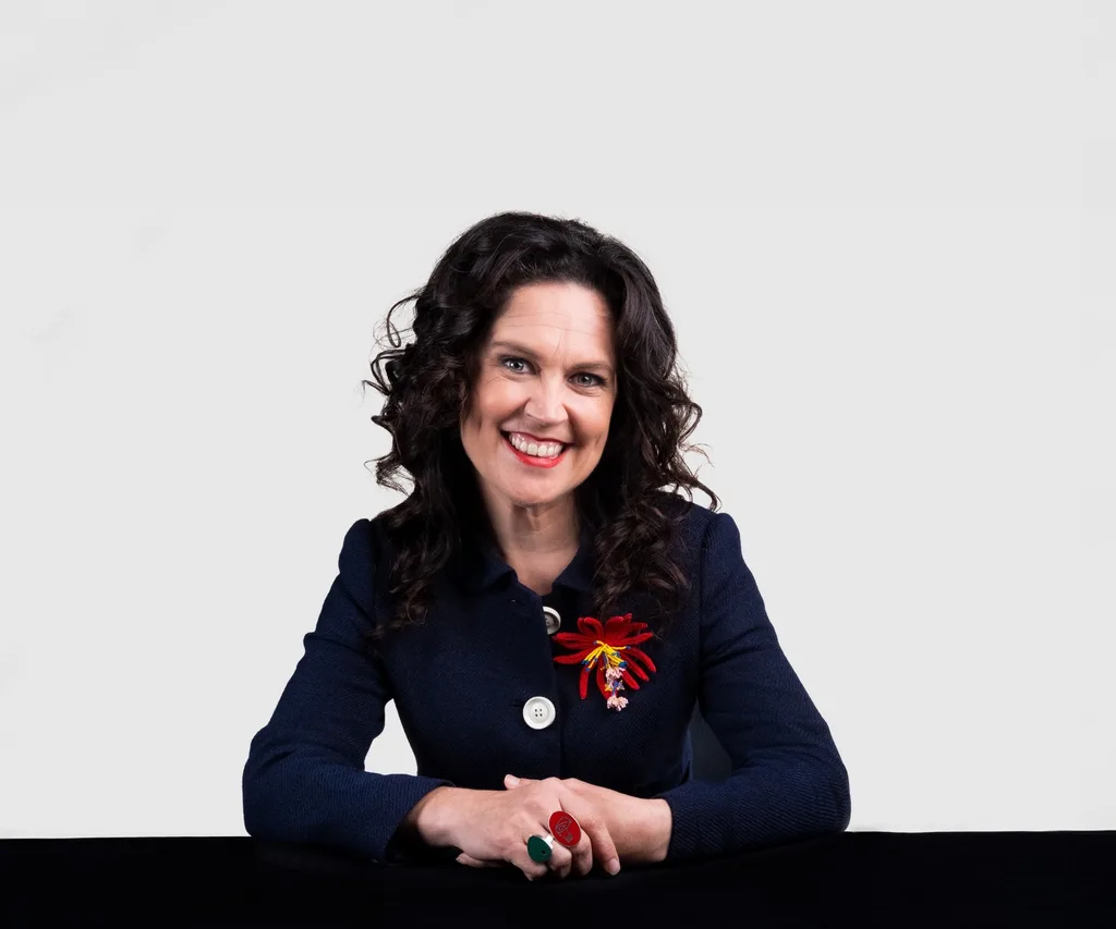 annabel crabb portrait sitting at black desk