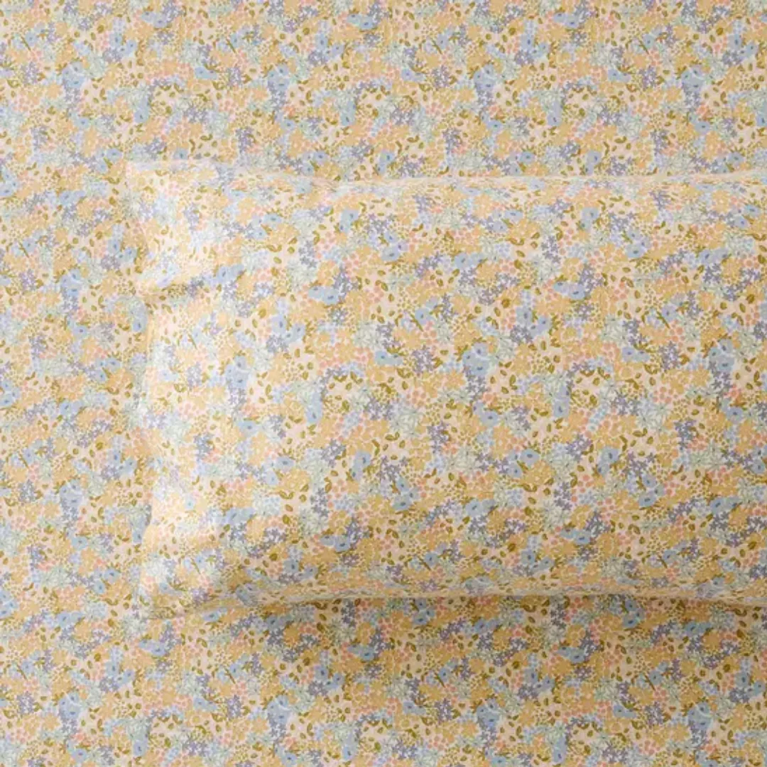 Close up image of a bed with a floral flannelette sheet, and matching pillowcase from Bed Bath N' Table